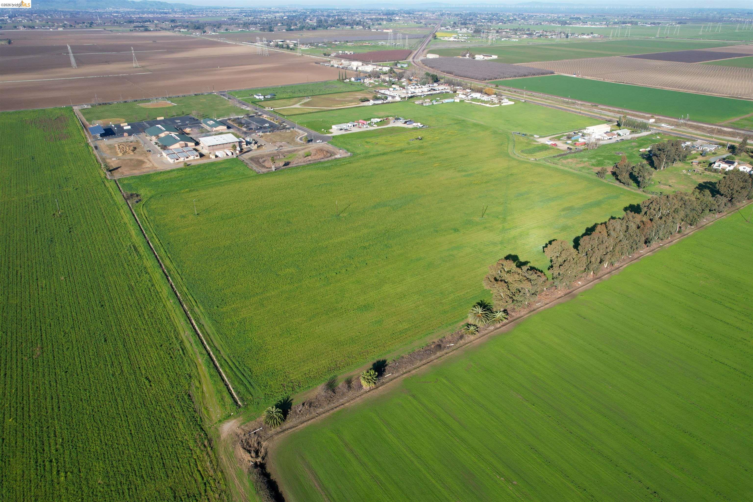 a view of a field with an ocean