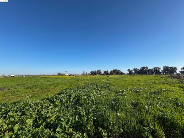 a view of a field with an outdoor space and seating
