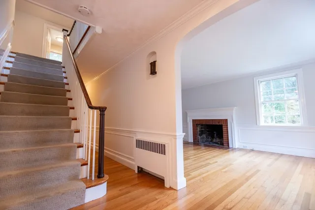 a view of entryway and hall with wooden floor