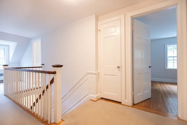 a view of a hallway with wooden floor and entryway