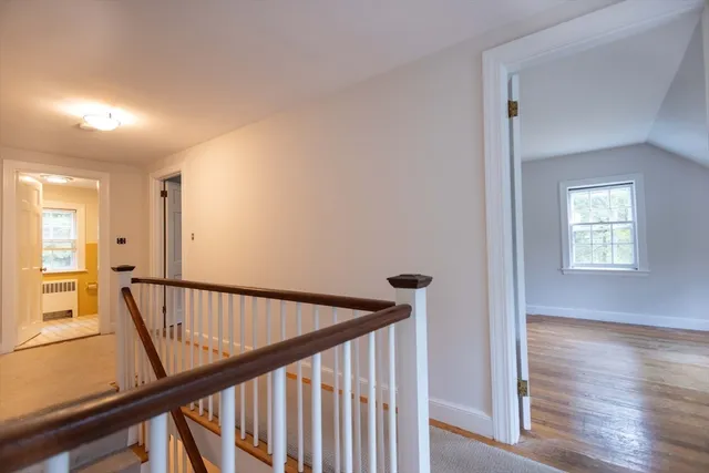 a white house that has a tree in front of it