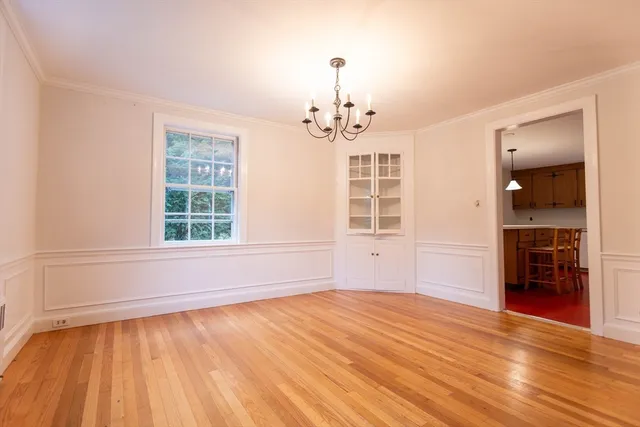 wooden floor chandelier and windows in a room
