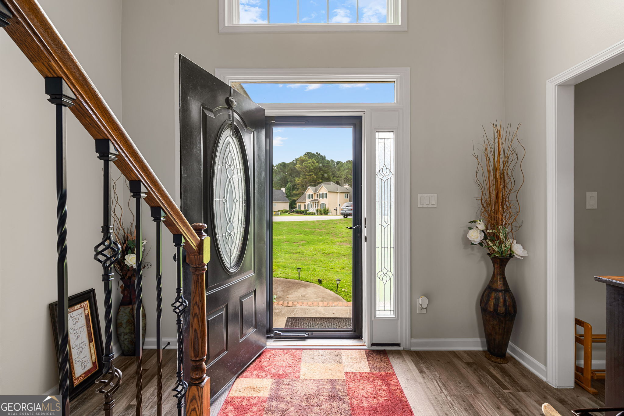 375 Gaelic Way Tyrone, GA 30290 - Photo 4 of 54 a view of a hallway with wooden floor and stairs