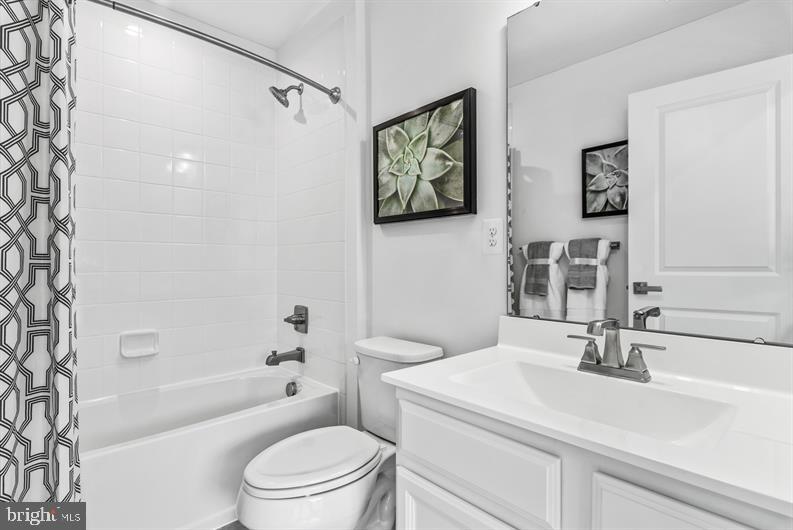 2928 Waterfront Way Street, Unit MOZART 4 Sparrows Point, MD 21219 - Photo 22 of 27 a bathroom with a sink a toilet a mirror and shower