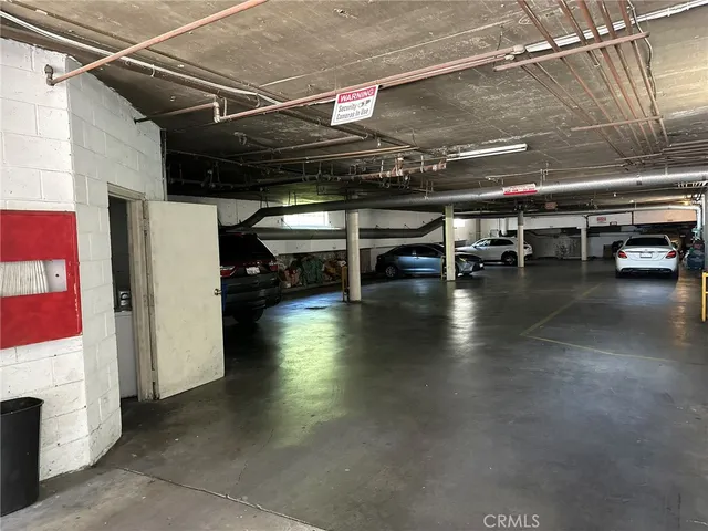 a view of parking garage with cars parked