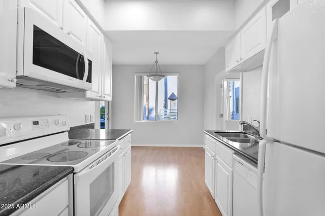 a kitchen that has a sink and a stove top oven