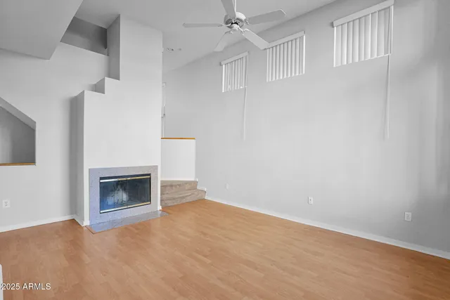 a view of an empty room with a fireplace