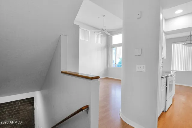 a view of hallway with stairs and wooden floor