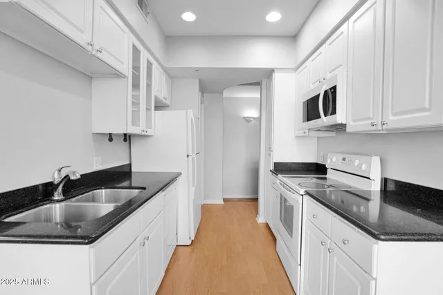 a kitchen that has a sink and a stove