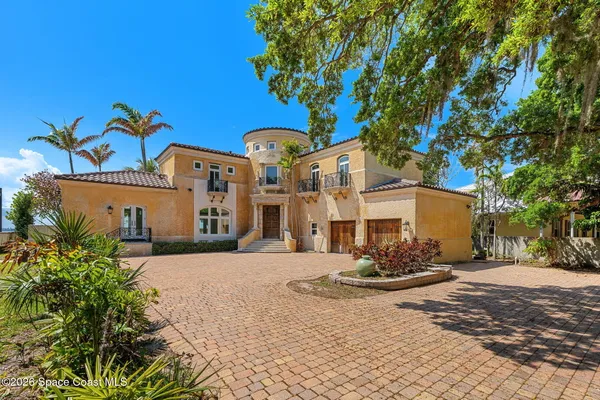 an aerial view of a house with a ocean view