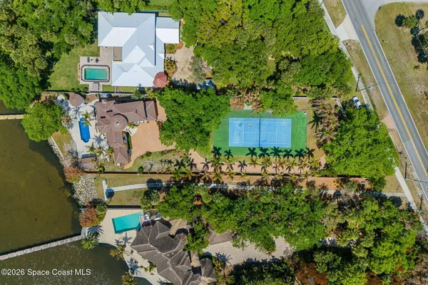 an aerial view of a house with a yard and garden