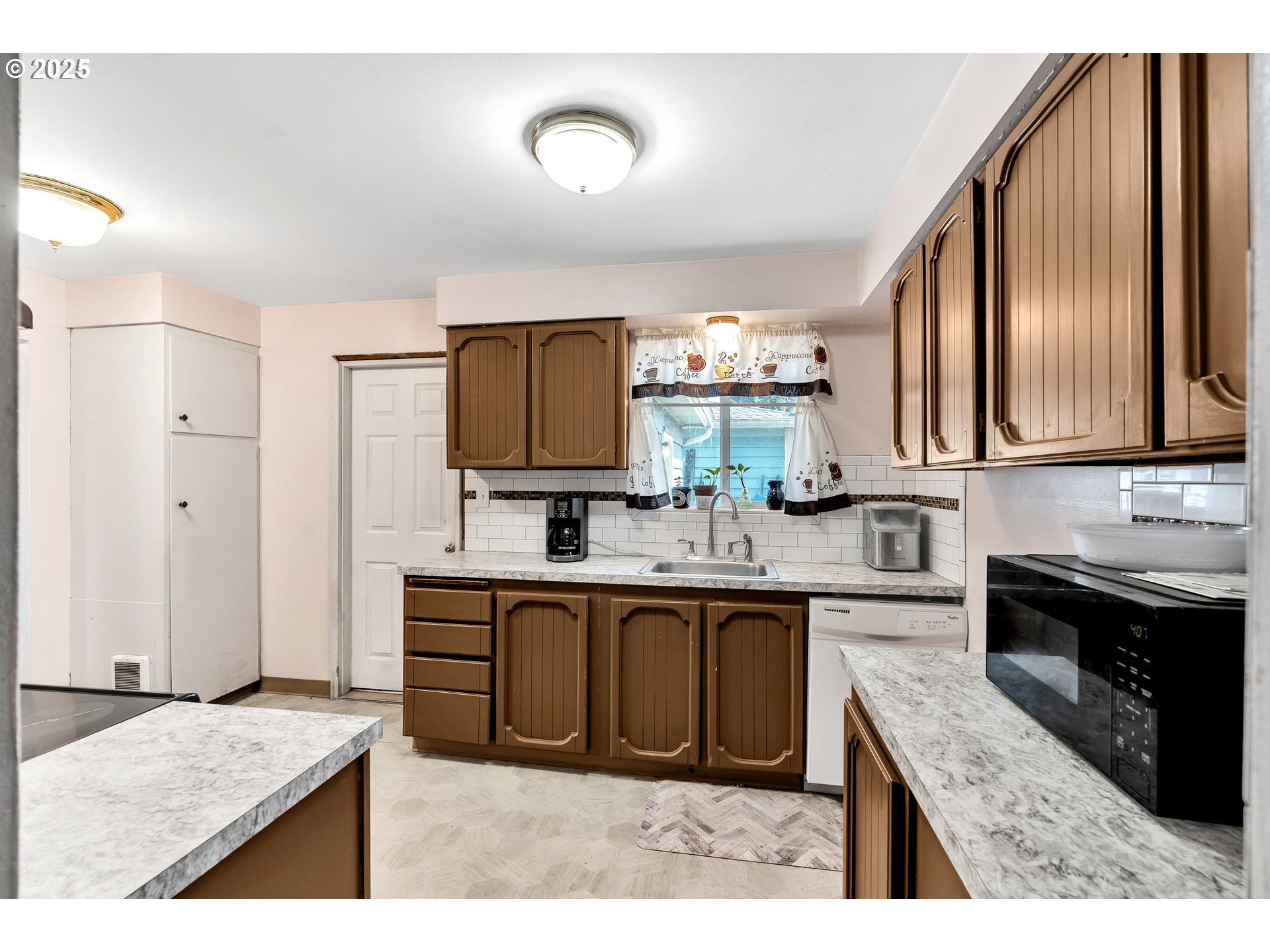 2951 Douglas Street Longview, WA 98632 - Photo 11 of 25 a kitchen with stainless steel appliances granite countertop a sink stove and refrigerator