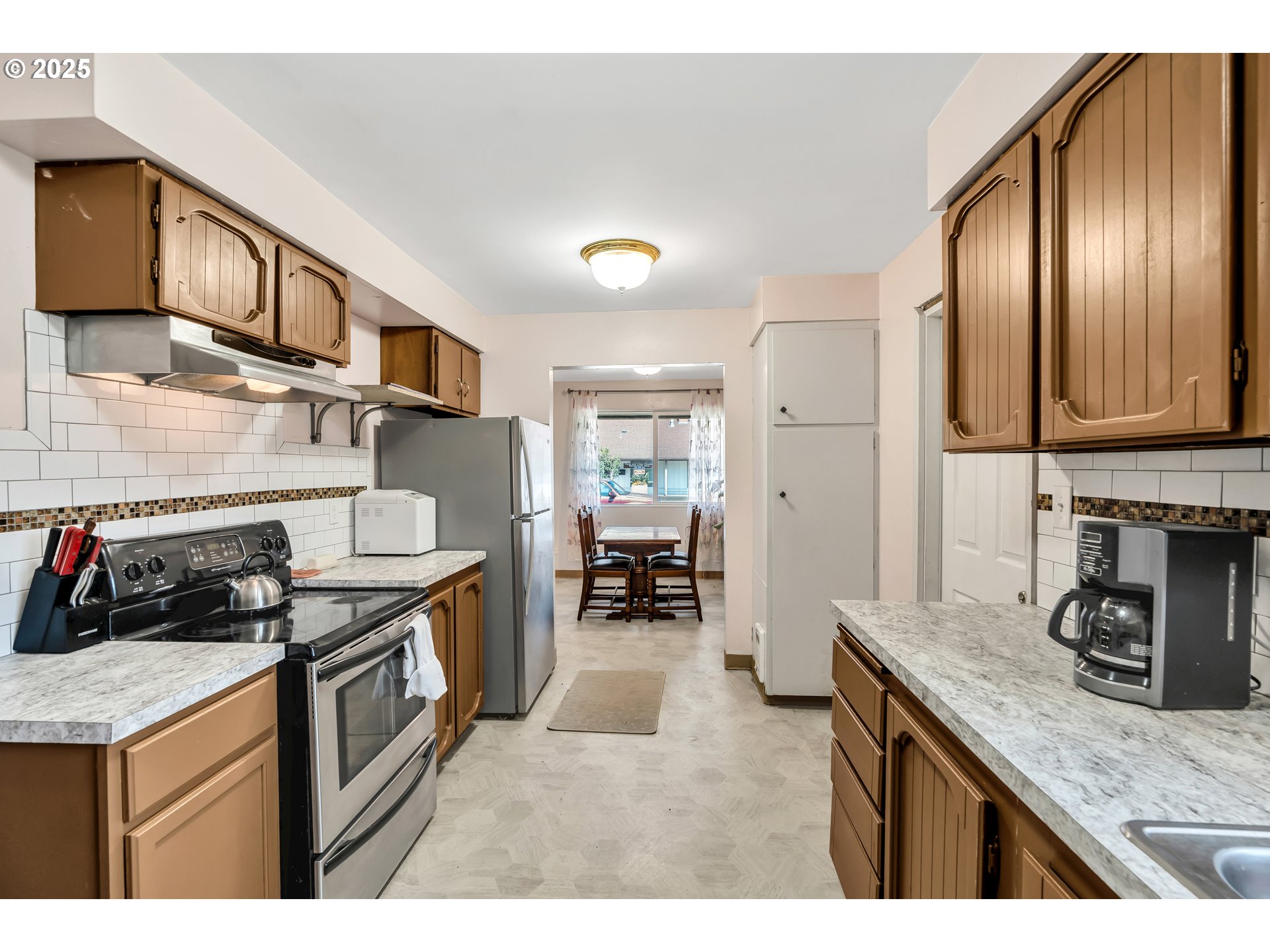 2951 Douglas Street Longview, WA 98632 - Photo 12 of 25 a kitchen with stainless steel appliances granite countertop a stove a sink and a refrigerator