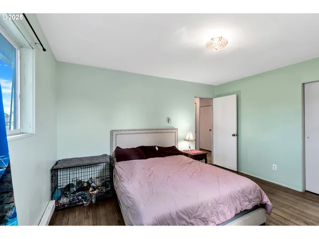 a bedroom with a bed and a lamp with window