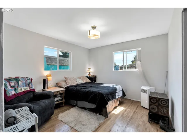 a bedroom with a bed window and a couch