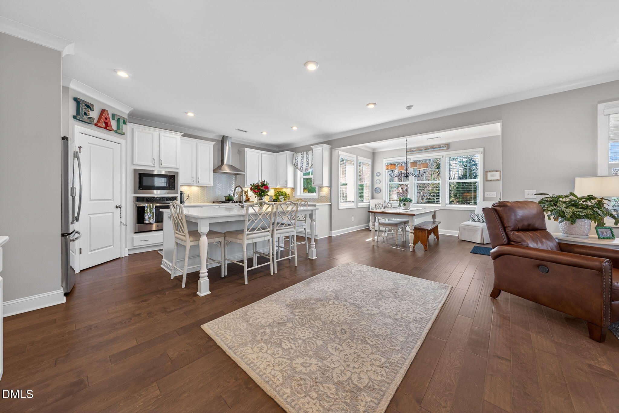 10009 Leesville Grove Drive Raleigh, NC 27613 - Photo 11 of 66 a living room with stainless steel appliances granite countertop furniture wooden floor and a view of kitchen