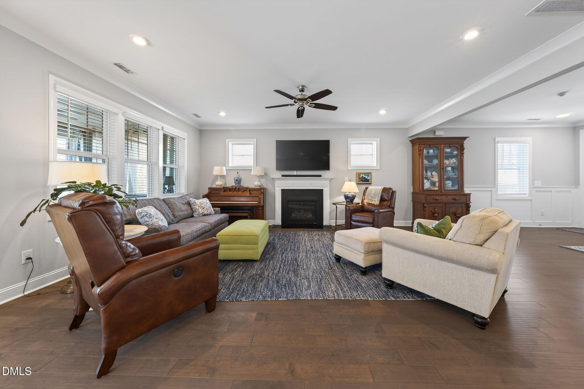 10009 Leesville Grove Drive Raleigh, NC 27613 - Photo 12 of 66 a living room with furniture a flat screen tv and a fireplace
