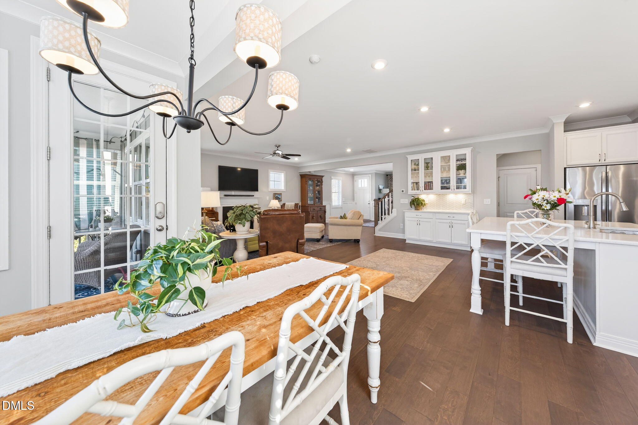 10009 Leesville Grove Drive Raleigh, NC 27613 - Photo 20 of 66 a view of a dining room with furniture a chandelier and wooden floor