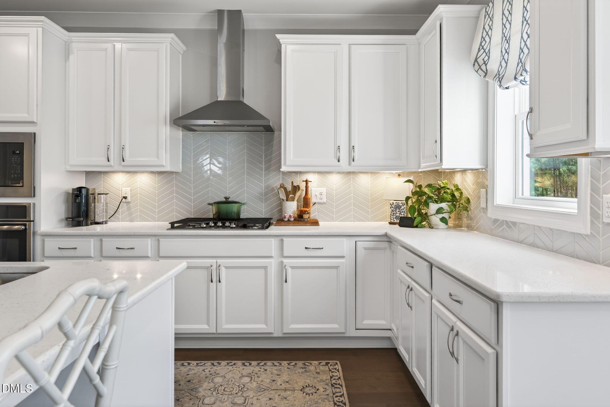 10009 Leesville Grove Drive Raleigh, NC 27613 - Photo 21 of 66 a kitchen with stainless steel appliances white cabinets and a stove
