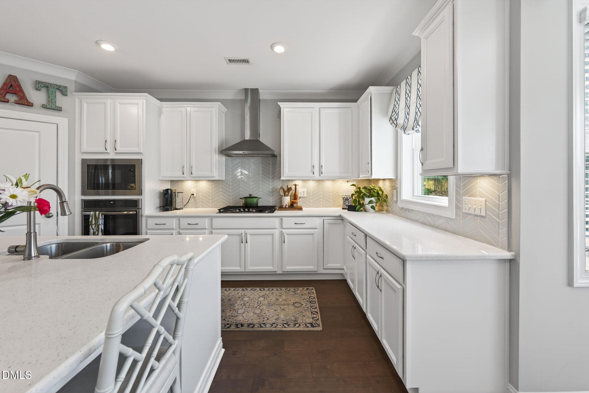 10009 Leesville Grove Drive Raleigh, NC 27613 - Photo 22 of 66 a kitchen with granite countertop a sink stainless steel appliances and white cabinets