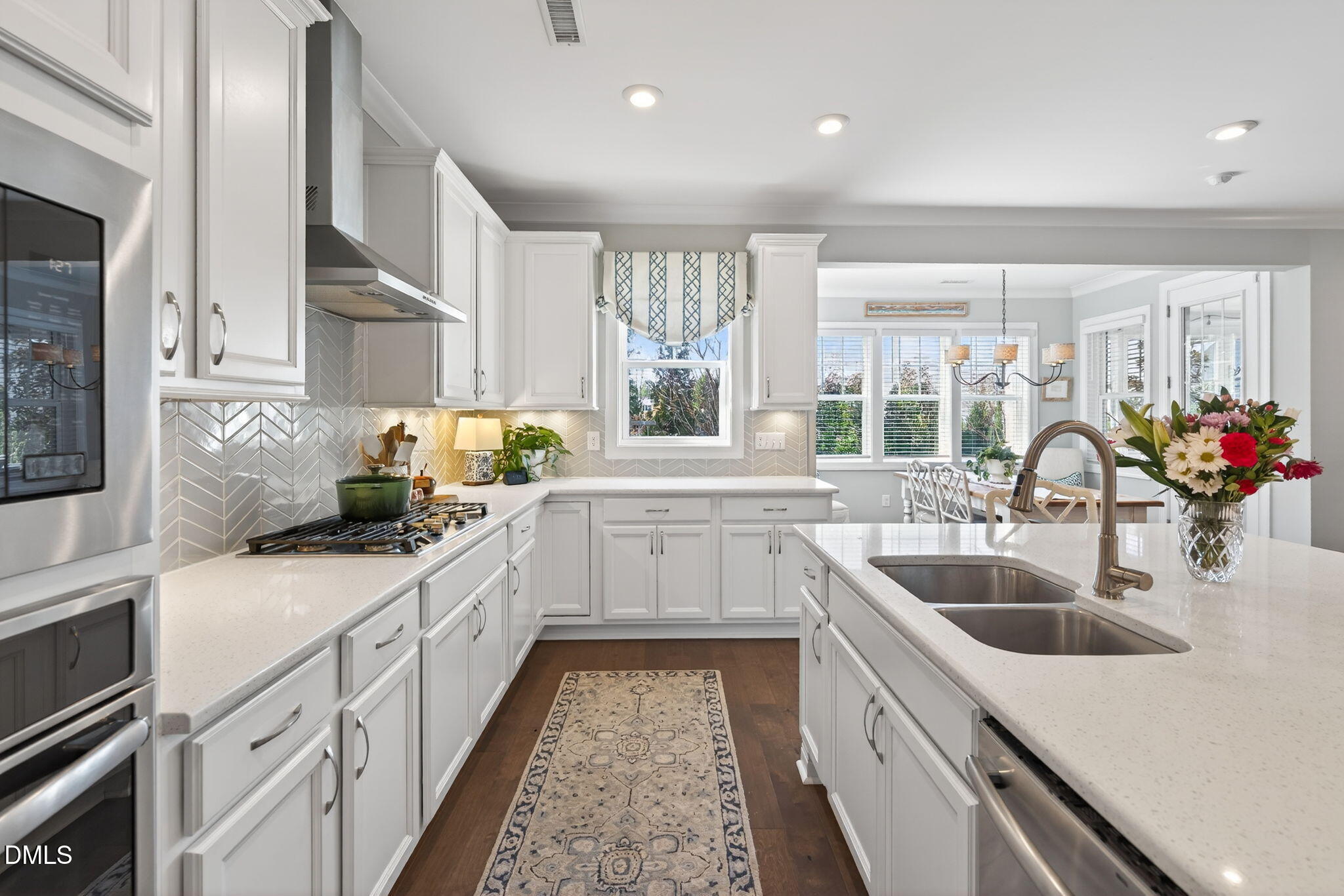 10009 Leesville Grove Drive Raleigh, NC 27613 - Photo 25 of 66 a kitchen with sink a stove and cabinets