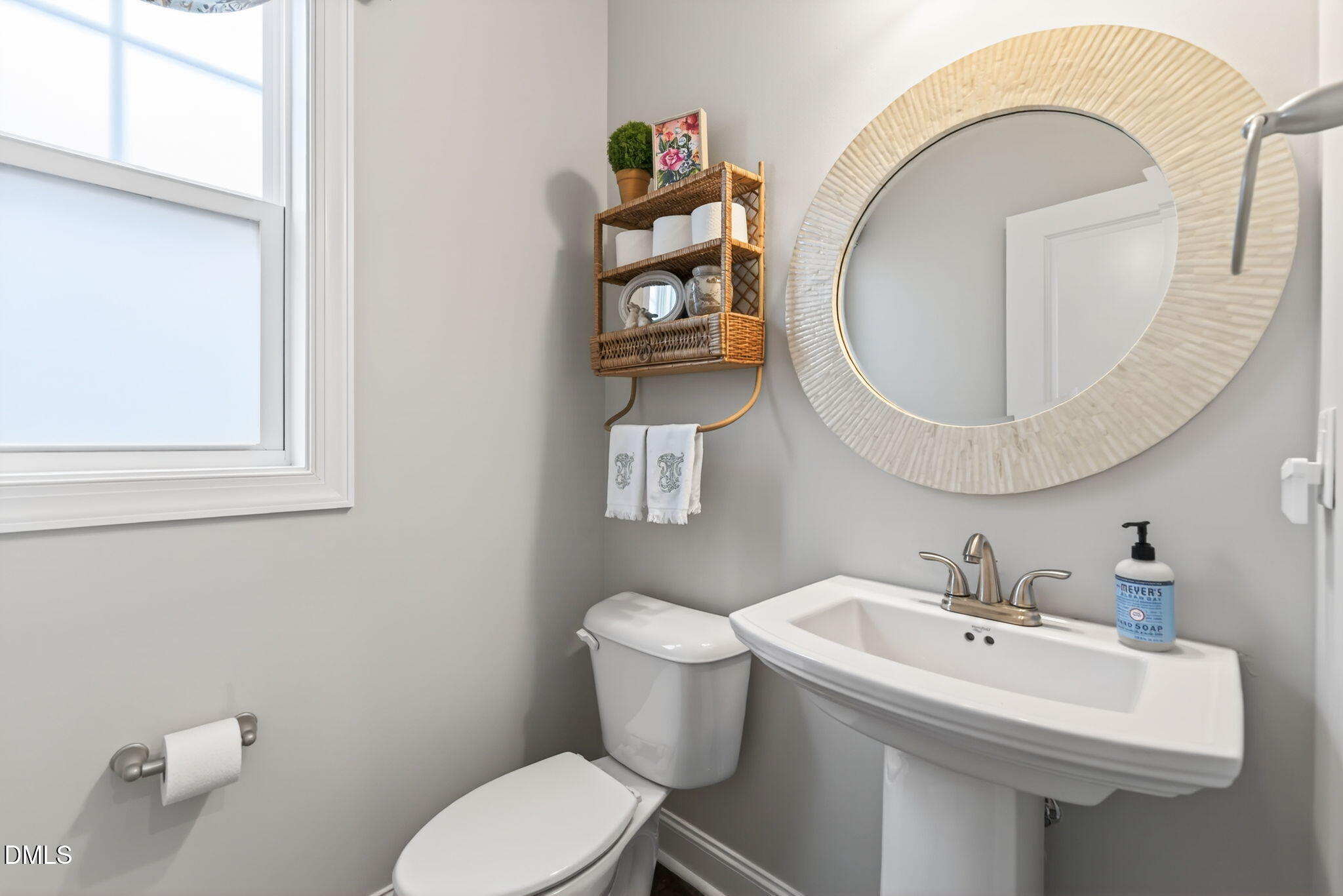 10009 Leesville Grove Drive Raleigh, NC 27613 - Photo 31 of 66 a bathroom with a toilet a sink and mirror