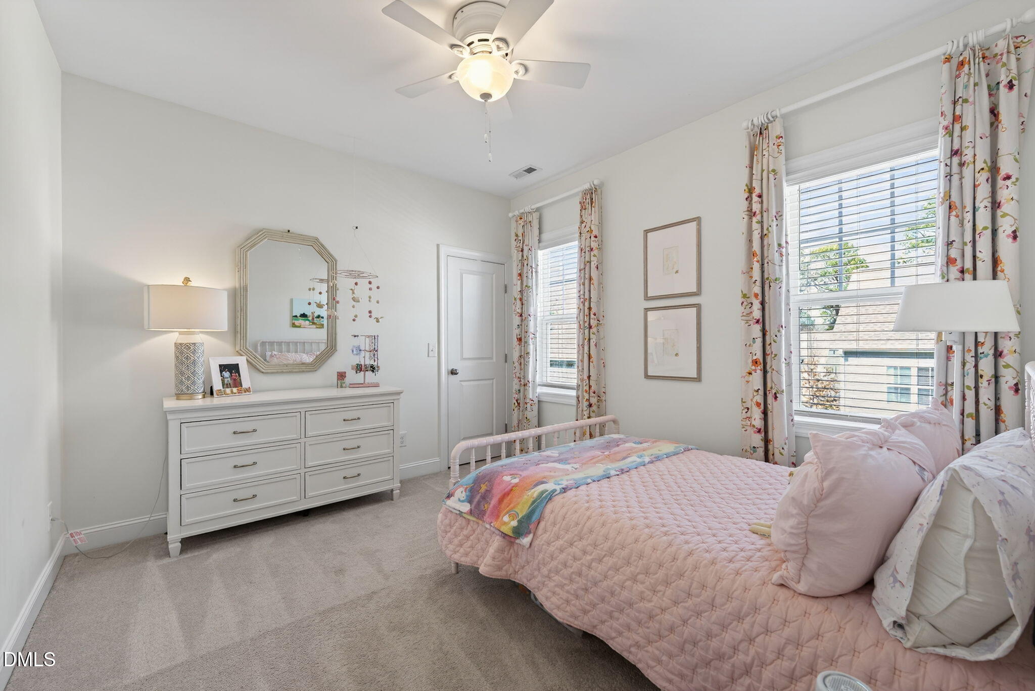 10009 Leesville Grove Drive Raleigh, NC 27613 - Photo 34 of 66 a bedroom with a bed and a chandelier