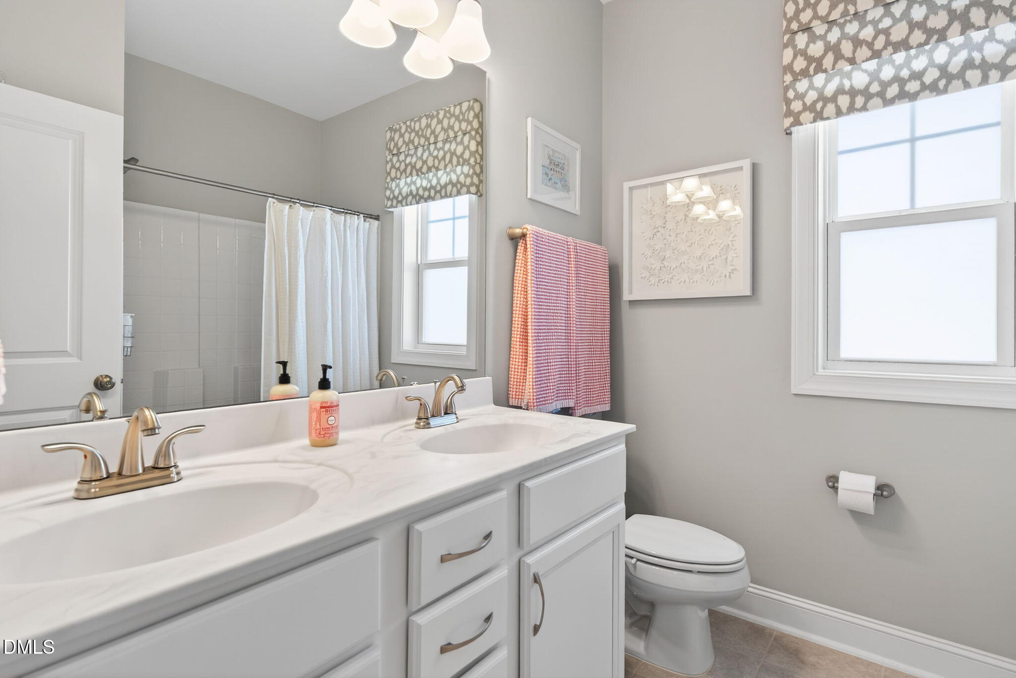 10009 Leesville Grove Drive Raleigh, NC 27613 - Photo 35 of 66 a bathroom with a sink a toilet and a mirror