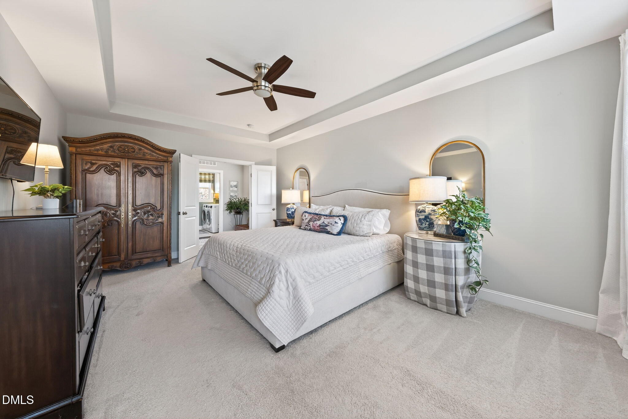 10009 Leesville Grove Drive Raleigh, NC 27613 - Photo 40 of 66 a spacious bedroom with a bed and a chandelier