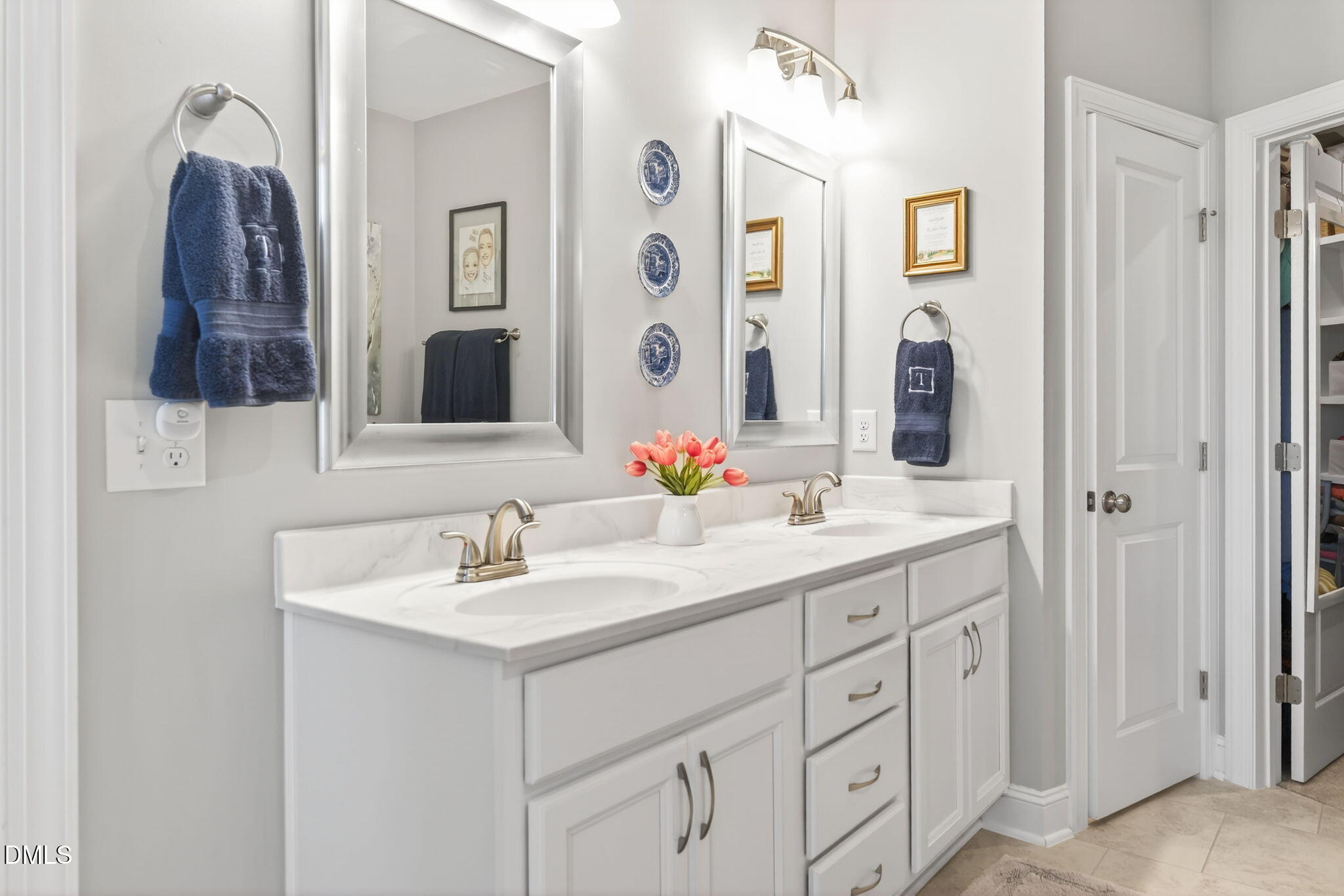 10009 Leesville Grove Drive Raleigh, NC 27613 - Photo 45 of 66 a bathroom with double sink and a mirror