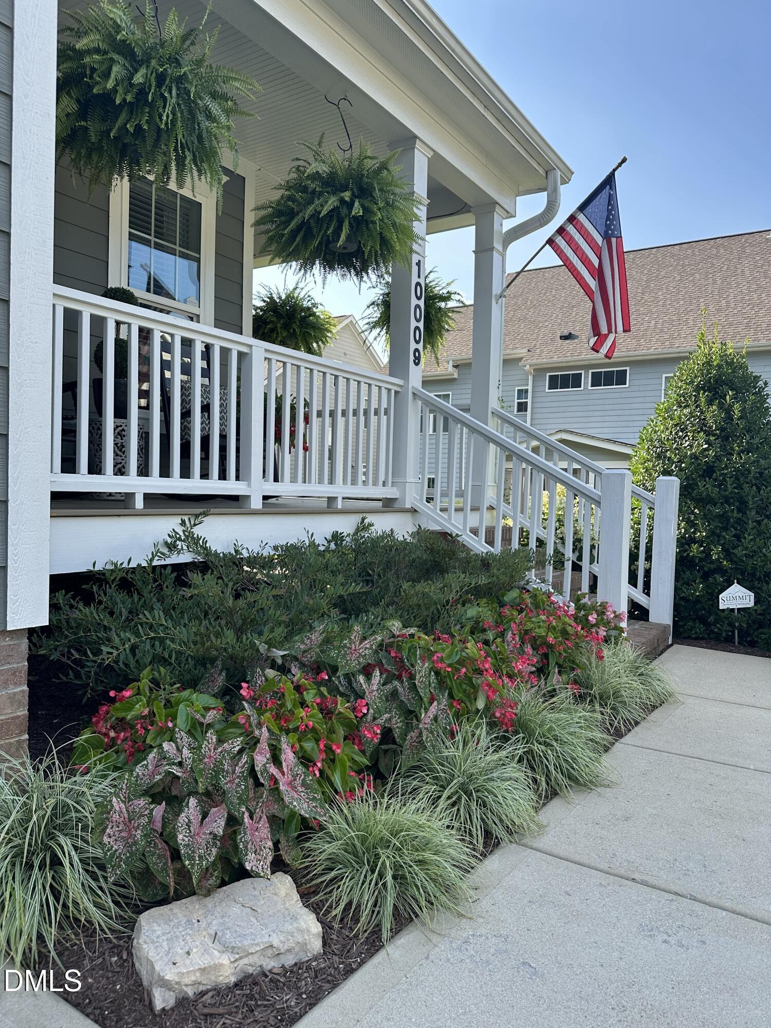 10009 Leesville Grove Drive Raleigh, NC 27613 - Photo 59 of 66 a front view of a house with a yard and potted plants