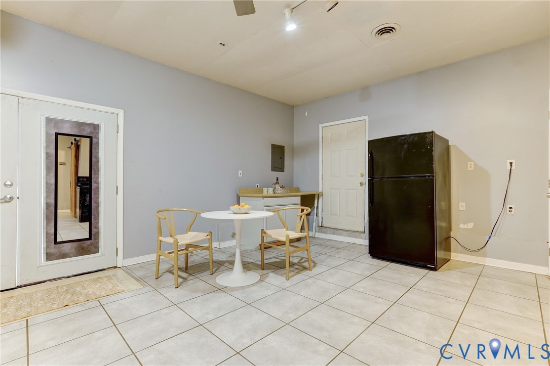 661 Greencastle Road Chesterfield, VA 23236 - Photo 24 of 28 a living room with a black white checkered floor with a dining table and chair