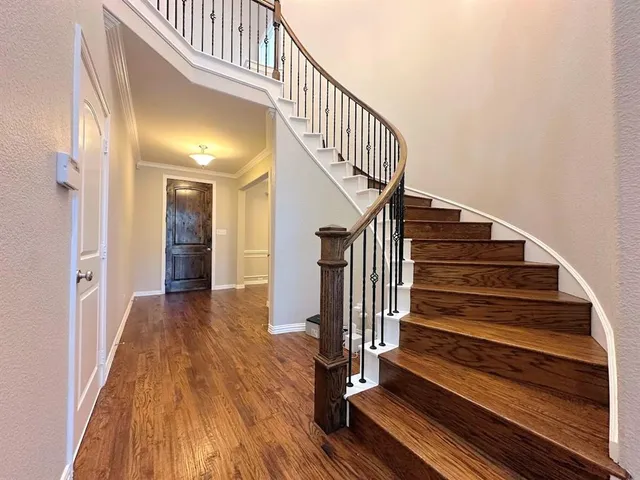 a view of entryway and hall with wooden floor
