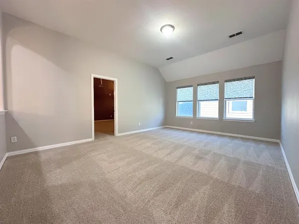 an empty room with windows and closet