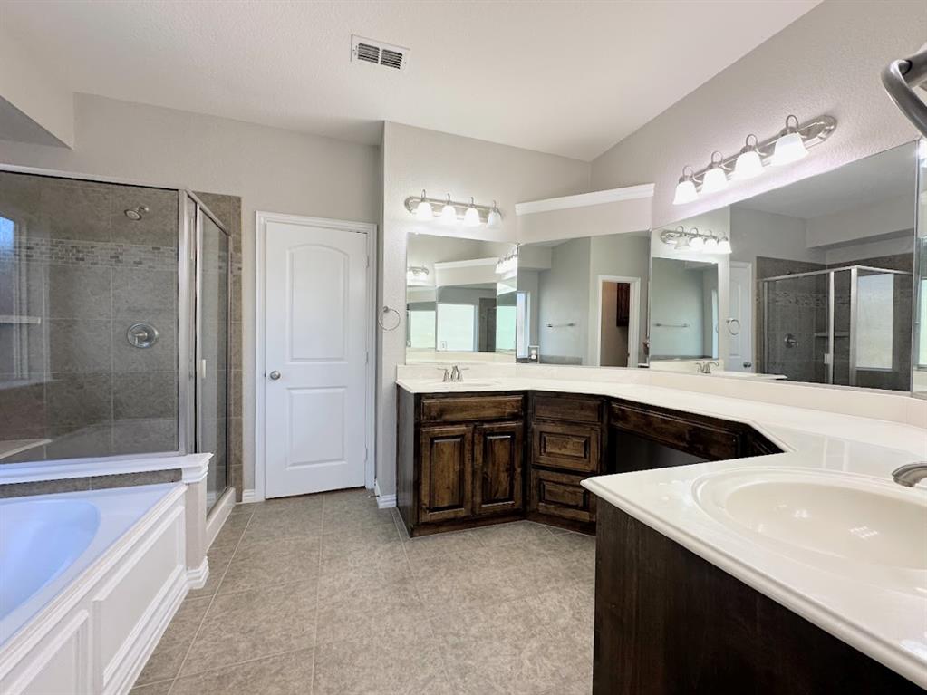 2453 Ranchview Drive Little Elm, TX 75068 - Photo 18 of 22 a bathroom with a granite countertop sink mirror and shower