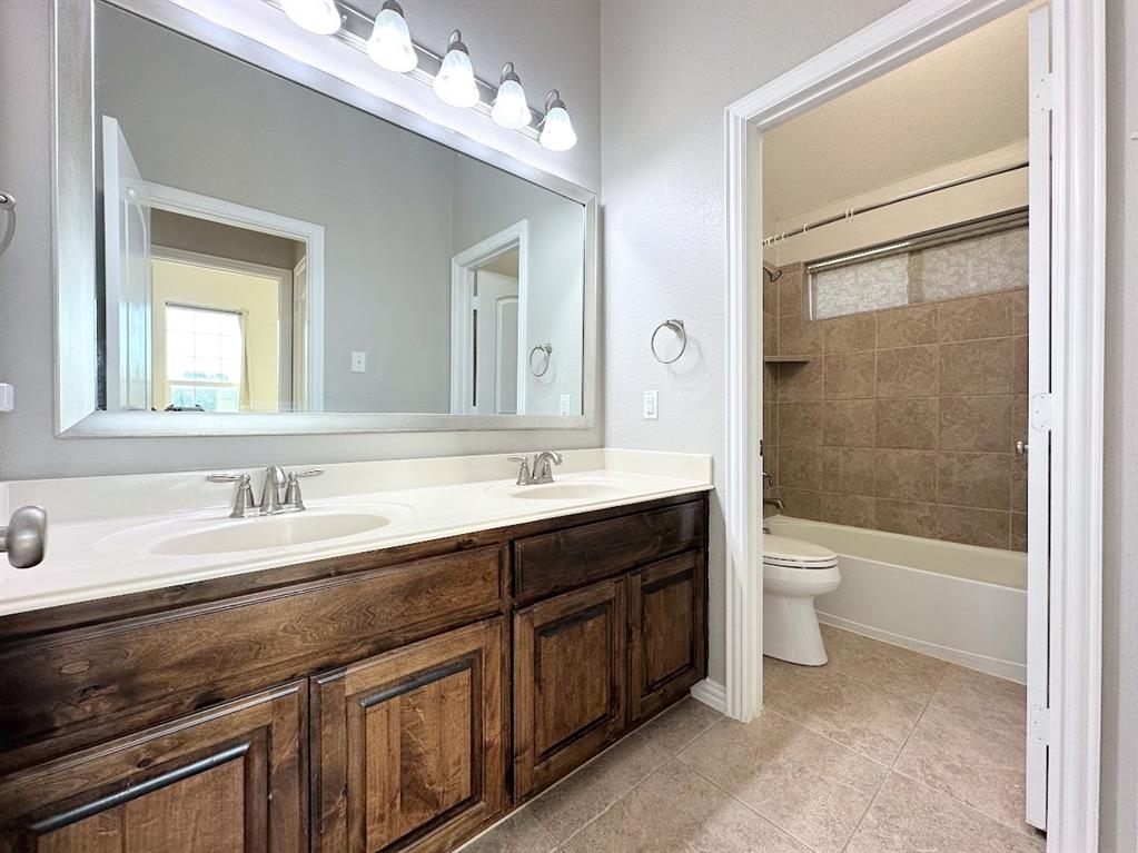 2453 Ranchview Drive Little Elm, TX 75068 - Photo 20 of 22 a bathroom with a sink a toilet and shower