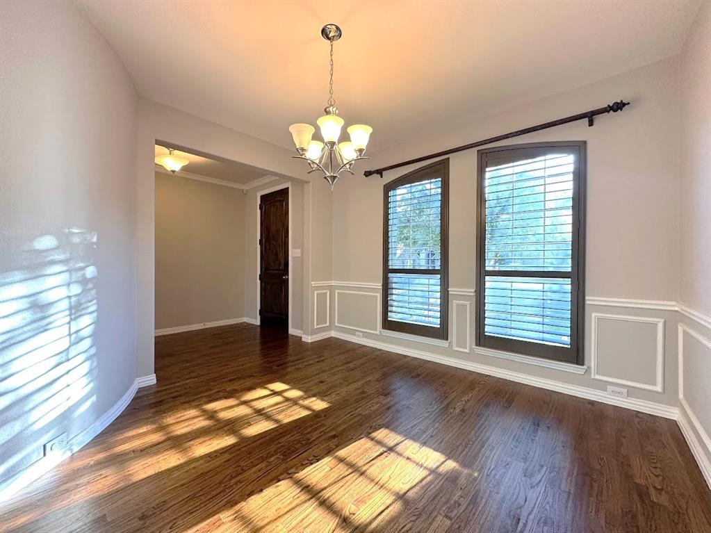 2453 Ranchview Drive Little Elm, TX 75068 - Photo 2 of 22 a view of an empty room with wooden floor and a window