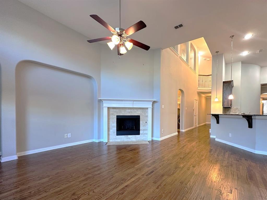 2453 Ranchview Drive Little Elm, TX 75068 - Photo 7 of 22 a view of an empty room with wooden floor and a fireplace