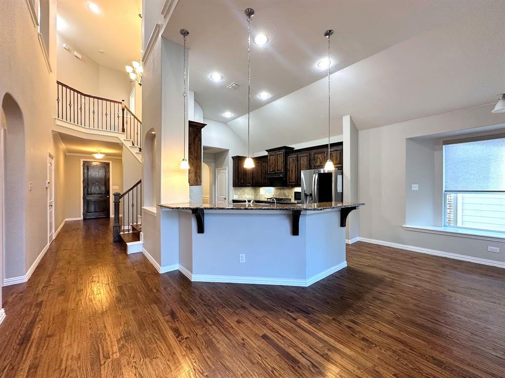 2453 Ranchview Drive Little Elm, TX 75068 - Photo 8 of 22 a large kitchen with stainless steel appliances granite countertop a large counter top a stove and a wooden floors