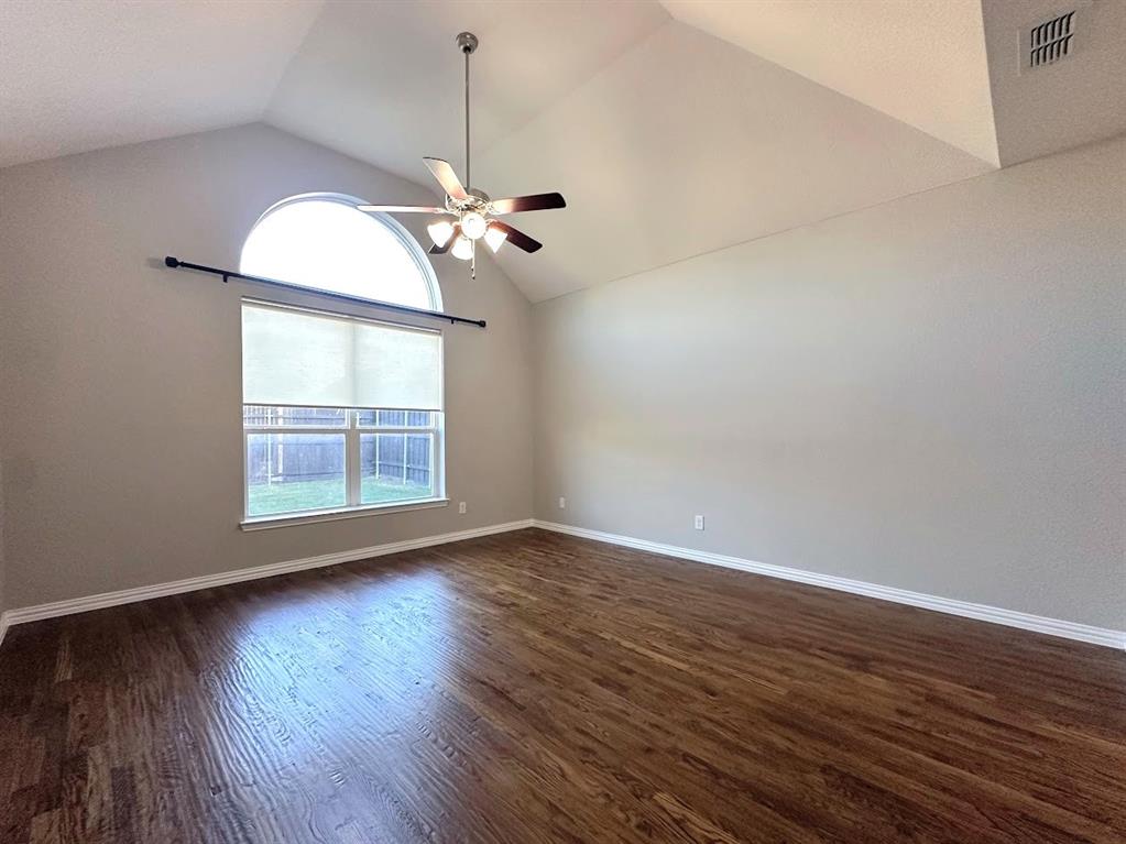2453 Ranchview Drive Little Elm, TX 75068 - Photo 9 of 22 a view of an empty room with wooden floor and a window