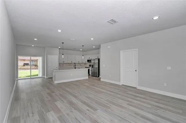 a view of a kitchen with a sink and a window