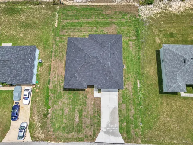 a aerial view of a house with a yard