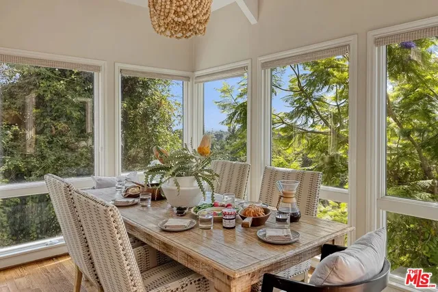a dining room with furniture a large window and a table