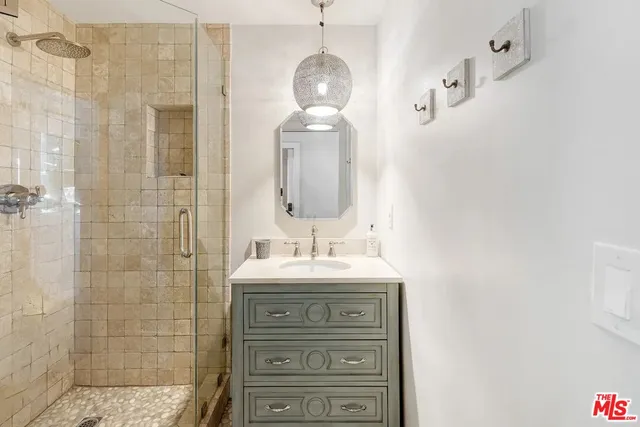 a bathroom with a granite countertop sink a toilet and shower