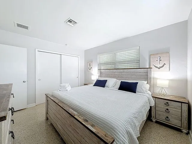 a bedroom with a bed and a window