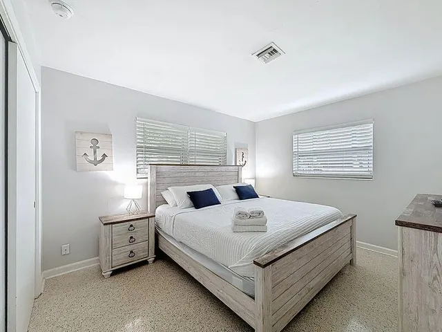 a bedroom with a bed and a night stand