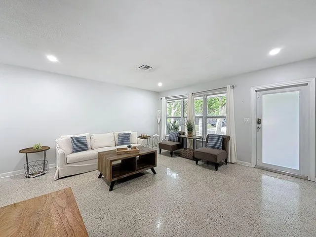 a living room with furniture and a large window