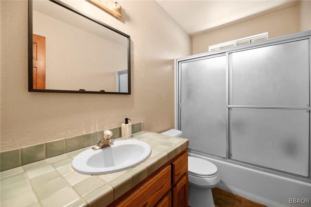 252 Riverside Avenue Sugarloaf, CA 92386 - Photo 12 of 29 a bathroom with a sink toilet and mirror