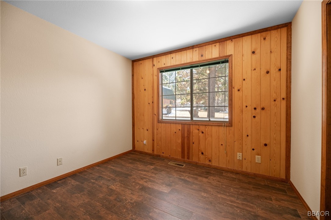 252 Riverside Avenue Sugarloaf, CA 92386 - Photo 14 of 29 an empty room with wooden floor and windows
