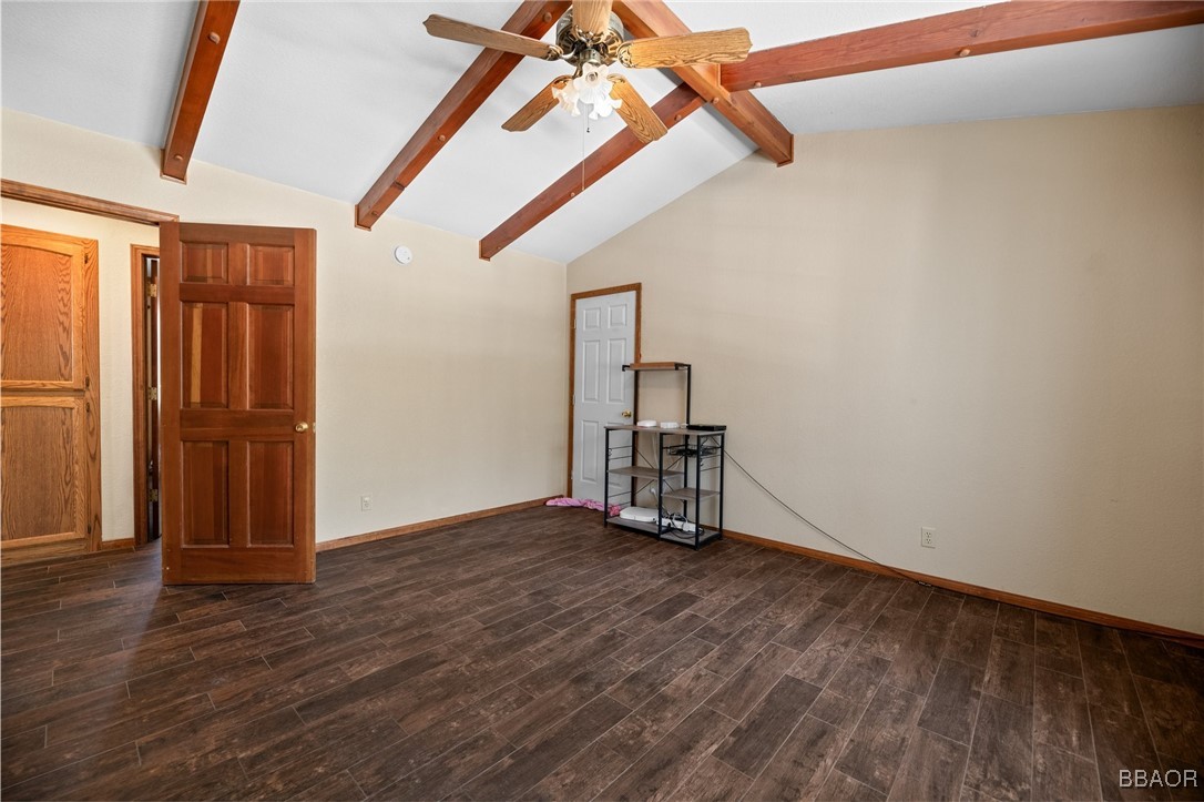 252 Riverside Avenue Sugarloaf, CA 92386 - Photo 21 of 29 an empty room with wooden floor staircase and windows
